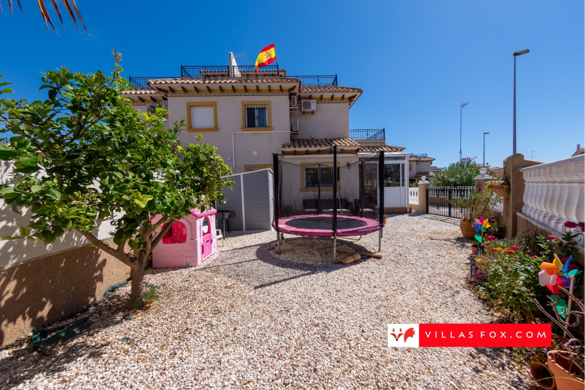 Orihuela Costa SW-facing 2-bedroom quad villa with garden, communal pool, close to La Zenia Boulevard