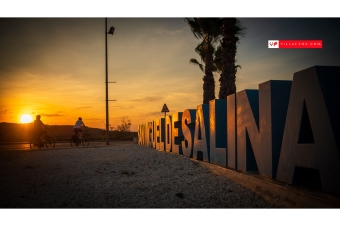 San Miguel de Salinas cyclists and town sign at sunset San Miguel de Salinas cyclists and town sign at sunset